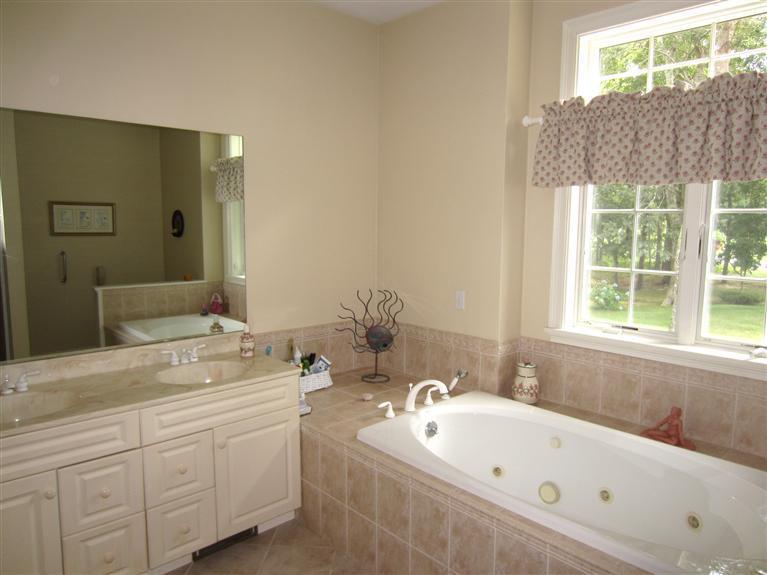 86 Howes Path Dennis, MA 02638 - Photo 18 of 30 a bathroom with a tub sink and mirror