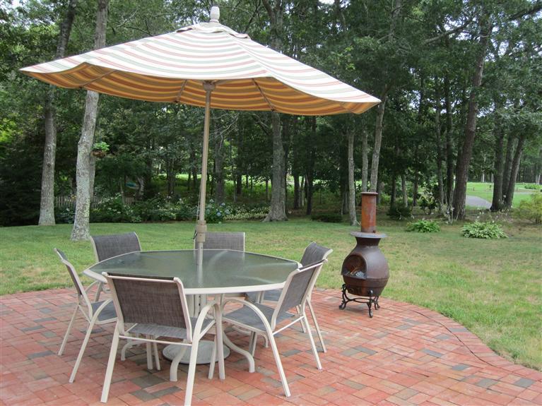 86 Howes Path Dennis, MA 02638 - Photo 27 of 30 a view of patio with chairs and table under an umbrella