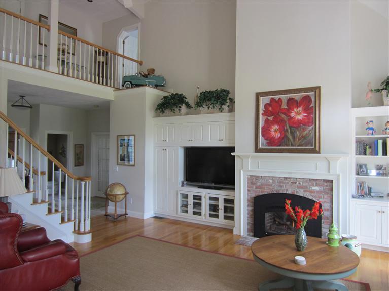 86 Howes Path Dennis, MA 02638 - Photo 6 of 30 a living room with furniture a flat screen tv and a fireplace