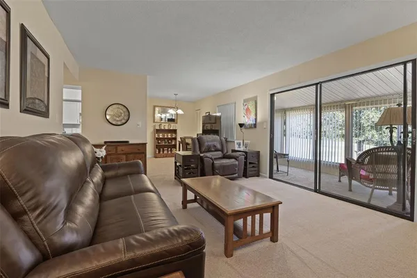 a view of a hallway to a livingroom with furniture