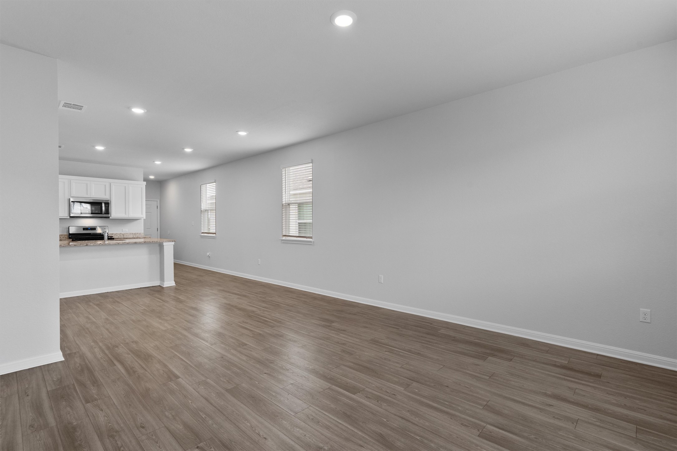 10613 Ridan Way Buda, TX 78610 - Photo 11 of 32 a view of kitchen with wooden floor and window