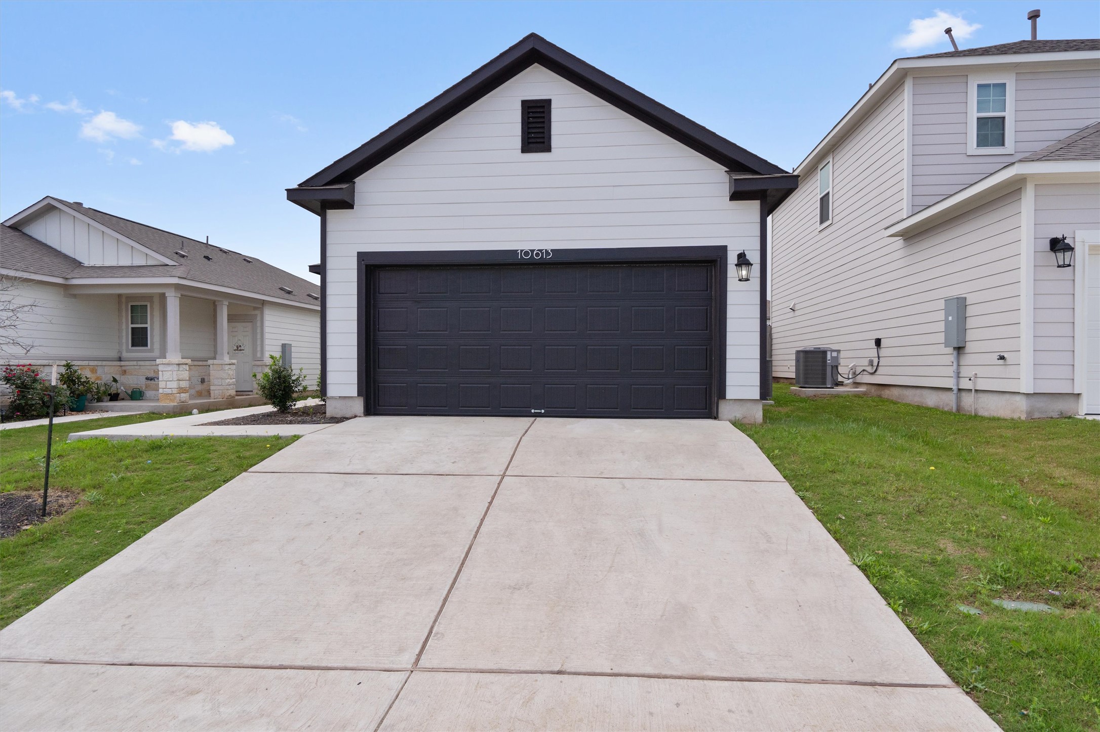 10613 Ridan Way Buda, TX 78610 - Photo 2 of 32 a front view of a house with a yard and garage