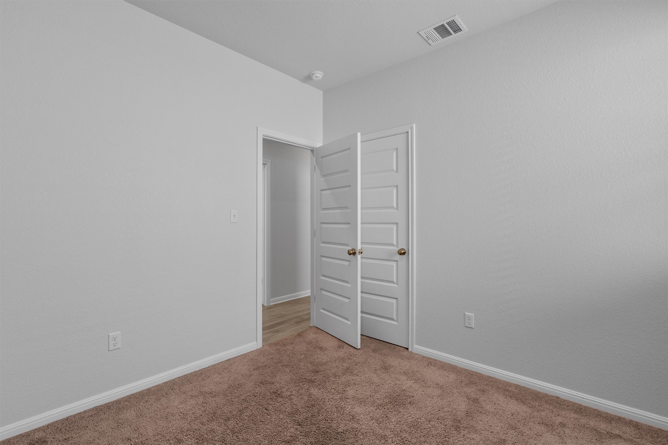 10613 Ridan Way Buda, TX 78610 - Photo 23 of 32 a view of walk in closet with empty racks