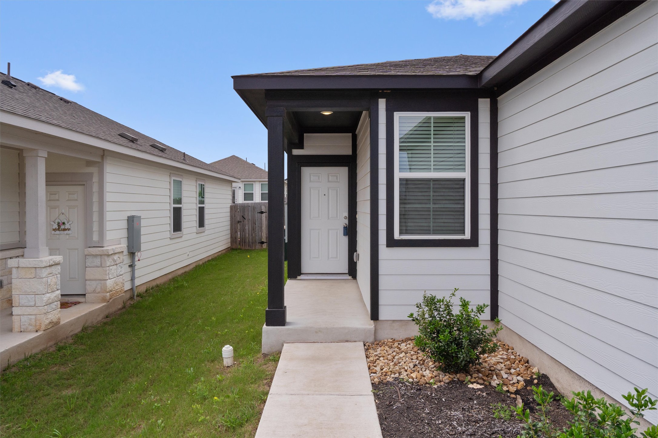 10613 Ridan Way Buda, TX 78610 - Photo 3 of 32 a front view of a house with garden