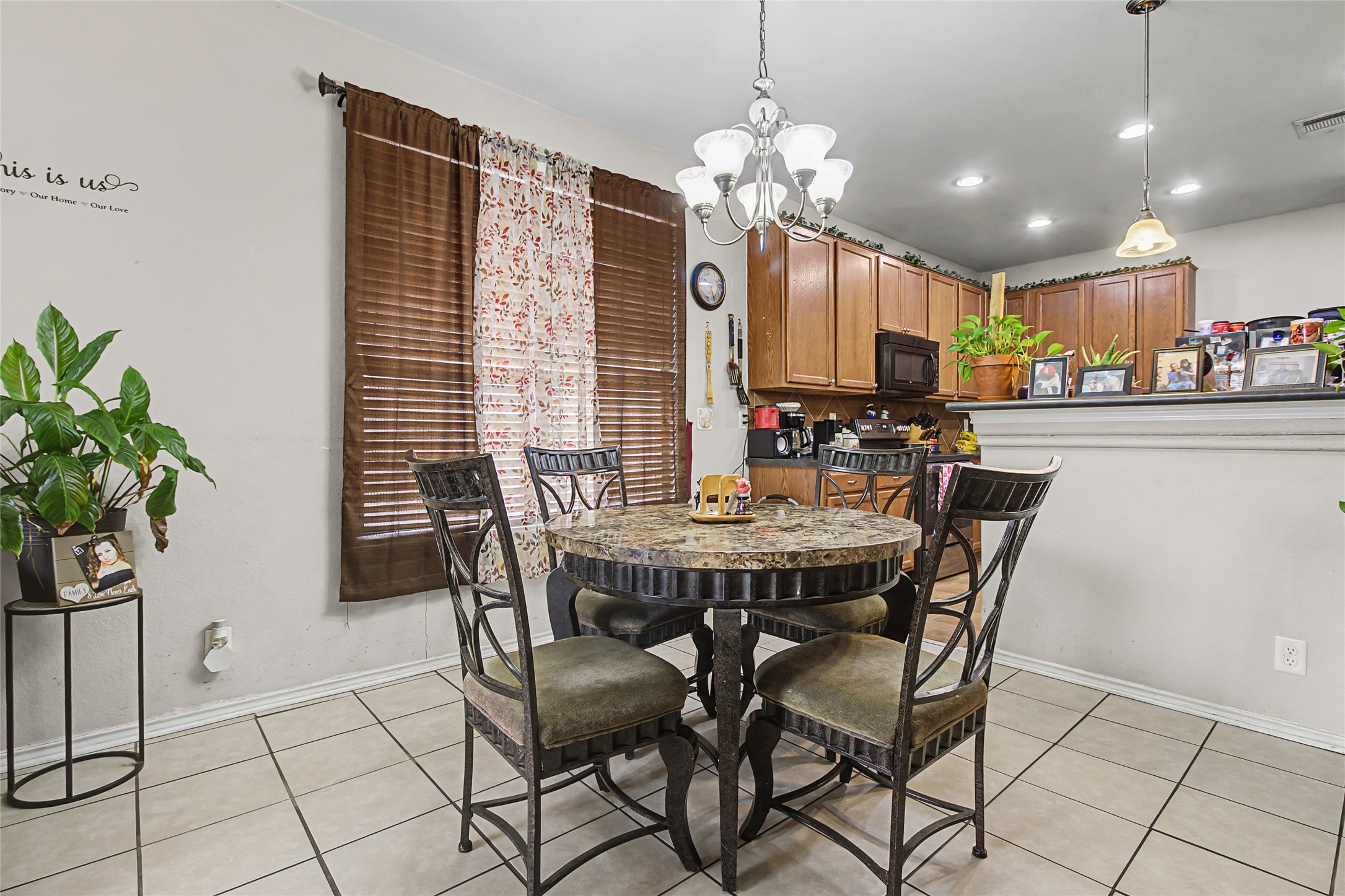344 Matthews Kyle, TX 78640 - Photo 6 of 15 Dining space with a chandelier and light tile patterned floors
