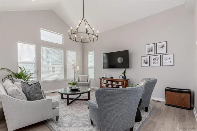 a living room with furniture and a chandelier