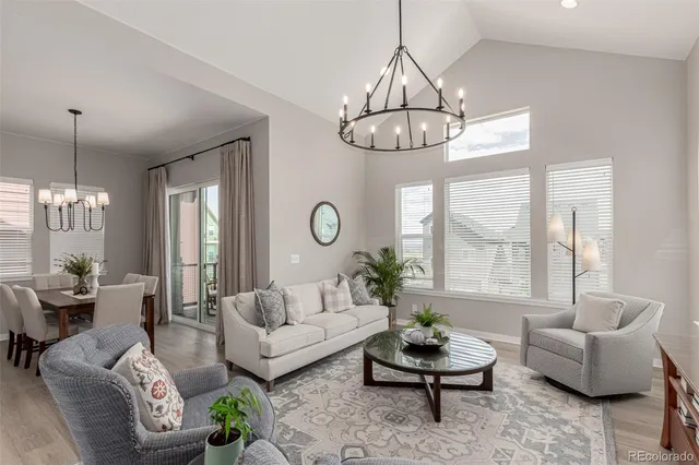 a living room with furniture chandelier and a chandelier