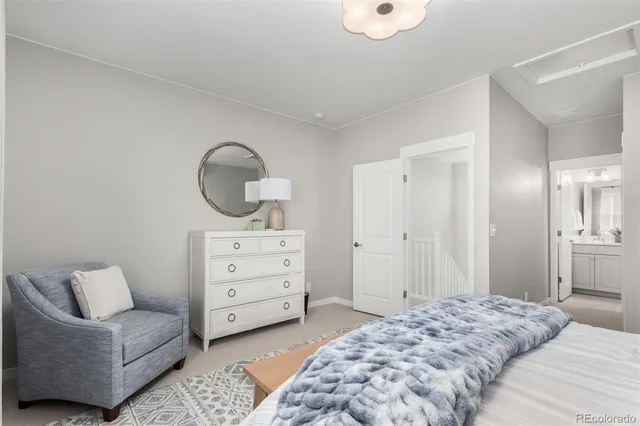 a bedroom with a furniture and a dresser