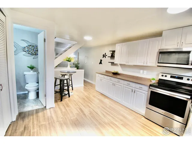 a view of a kitchen with furniture and an empty room
