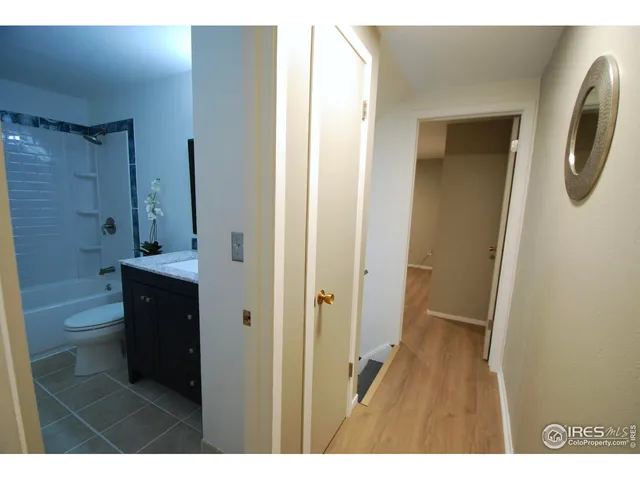 a view of a living room with a chair and floor to ceiling window