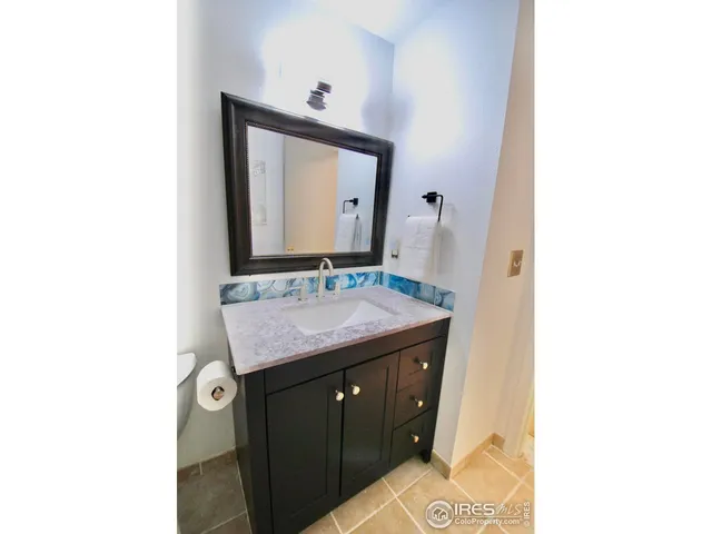 a bathroom with a sink vanity and a mirror