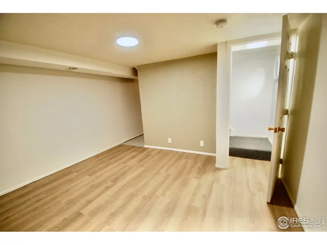 a view of an empty room and wooden floor