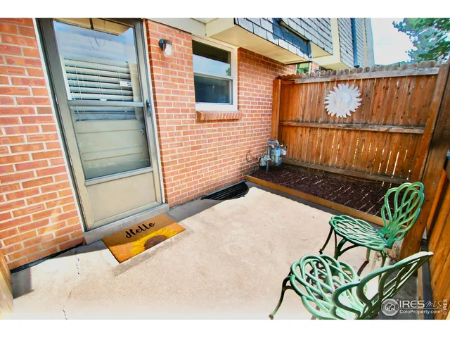 a open kitchen with stainless steel appliances granite countertop a refrigerator a sink a stove and white cabinets with wooden floor