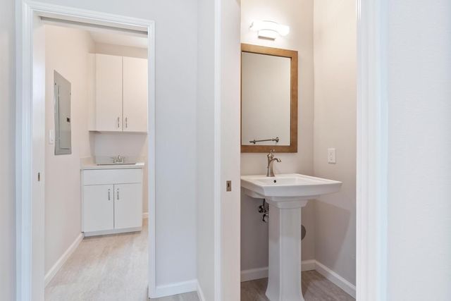 a bathroom with a sink a toilet and mirror