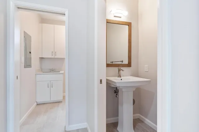 a bathroom with a sink a toilet and mirror