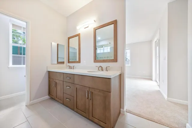 a bathroom with a double vanity sink mirror and double