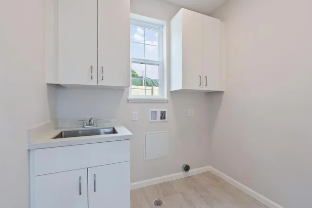 a bathroom with a sink and cabinets