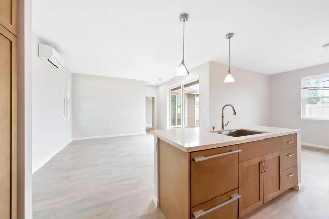 a view of a kitchen with a sink a window and appliances