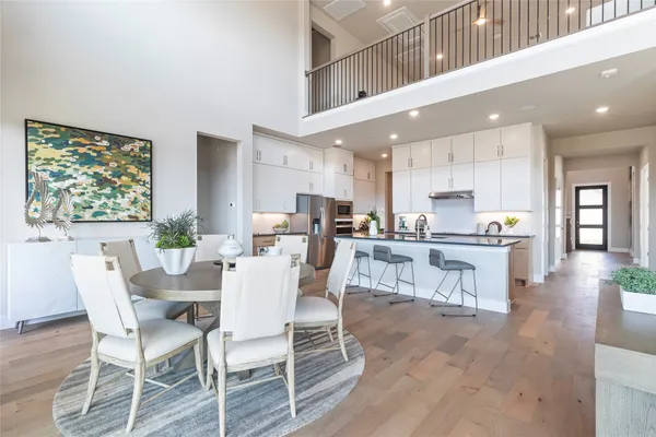 a view of kitchen with stainless steel appliances granite countertop cabinets and a dining table