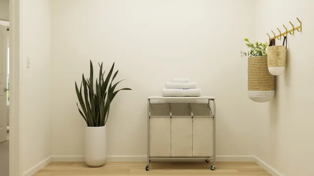 a living room with a couch and a potted plant