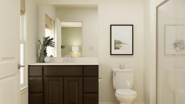 a bathroom with a toilet a sink and mirror