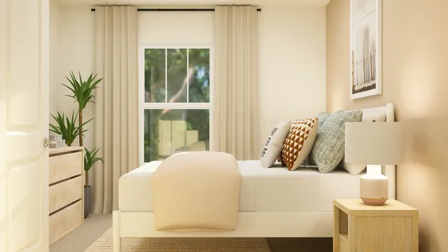 a bedroom with a bed and a potted plant