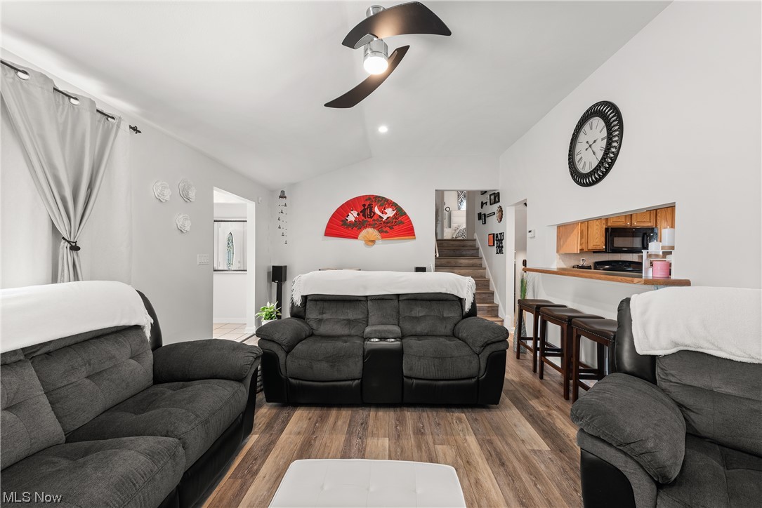 7094 Brandywine Road Parma Heights, OH 44130 - Photo 20 of 49 Living room featuring track lighting, ceiling fan, vaulted ceiling, and dark hardwood / wood-style floors