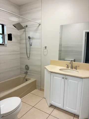 a bathroom with a sink toilet vanity and shower