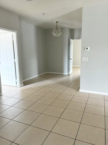 a view of an empty room and a window