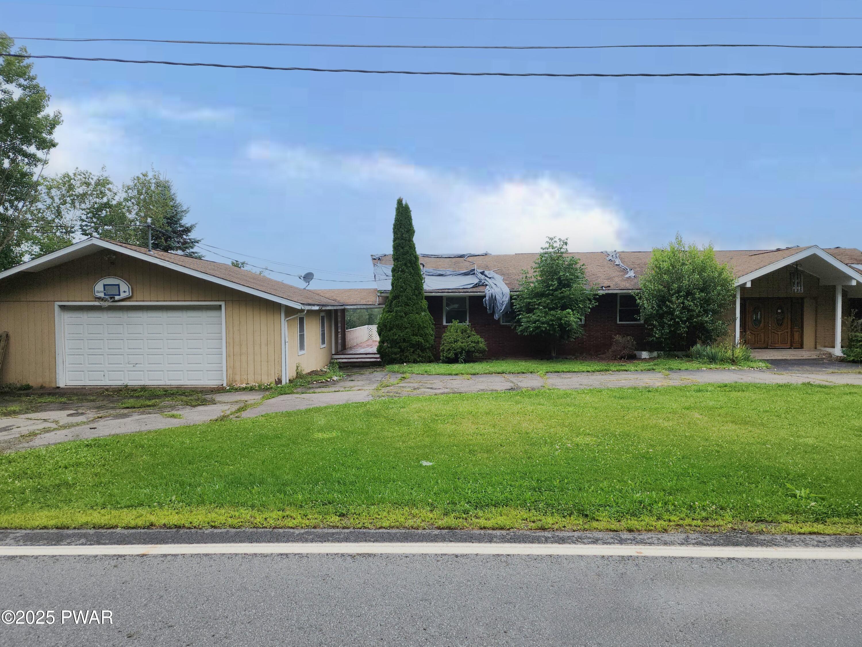 961 Aberdeen Road Moscow, PA 18444 - Photo 2 of 26 a view of a house with a yard and garage