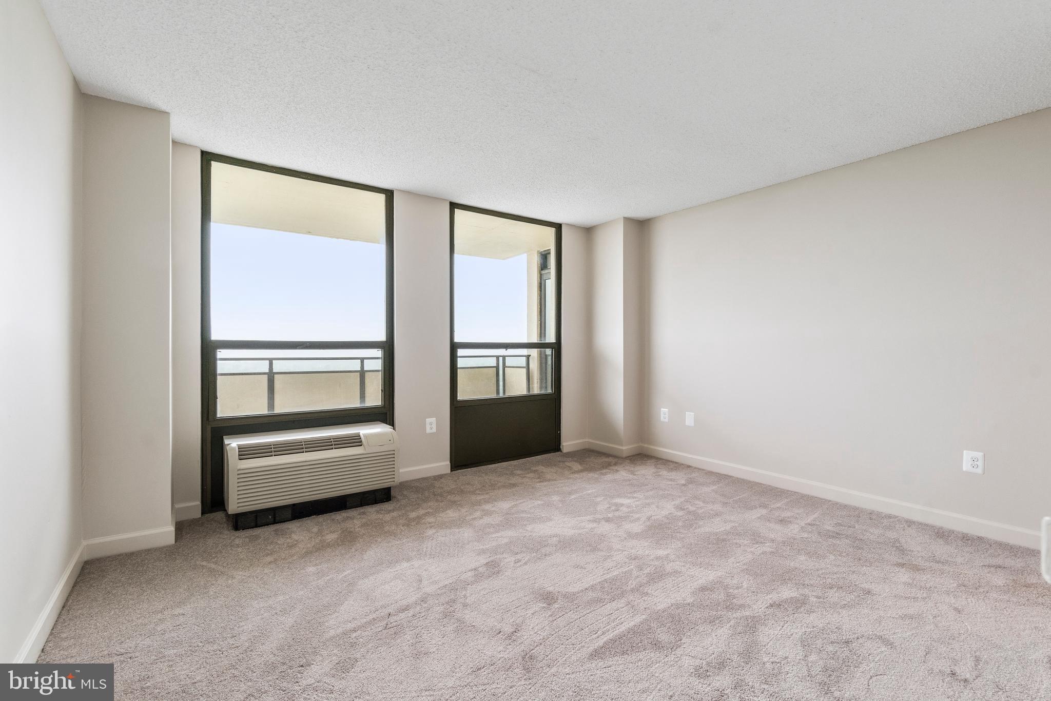 205 East Joppa Road, Unit 2703 Towson, MD 21286 - Photo 25 of 34 an empty room with a fireplace and windows