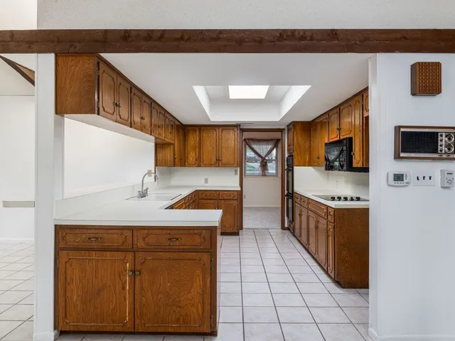 a kitchen with stainless steel appliances granite countertop a sink and a stove