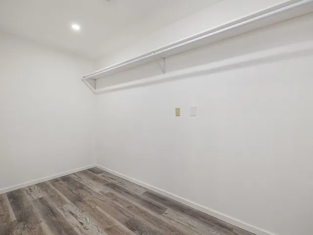 a view of a room with wooden floor