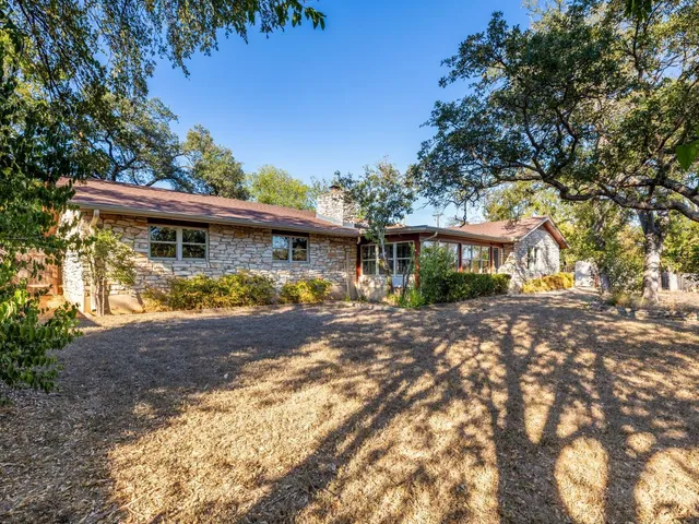 a view of a house with garden and trees