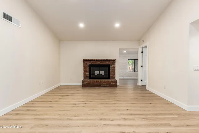 a view of an empty room with a fireplace