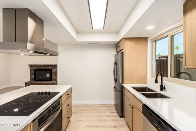 a kitchen with granite countertop a stove and a sink