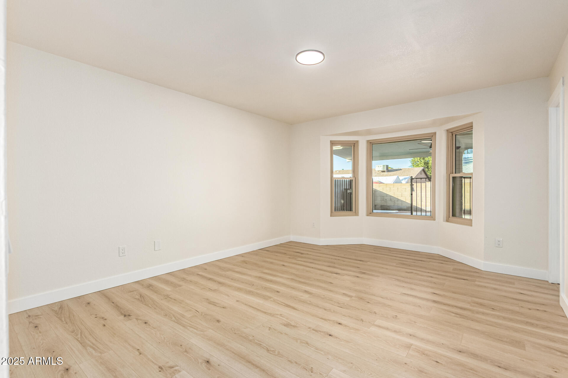 1514 West Loughlin Drive Chandler, AZ 85224 - Photo 16 of 33 an empty room with wooden floor and windows