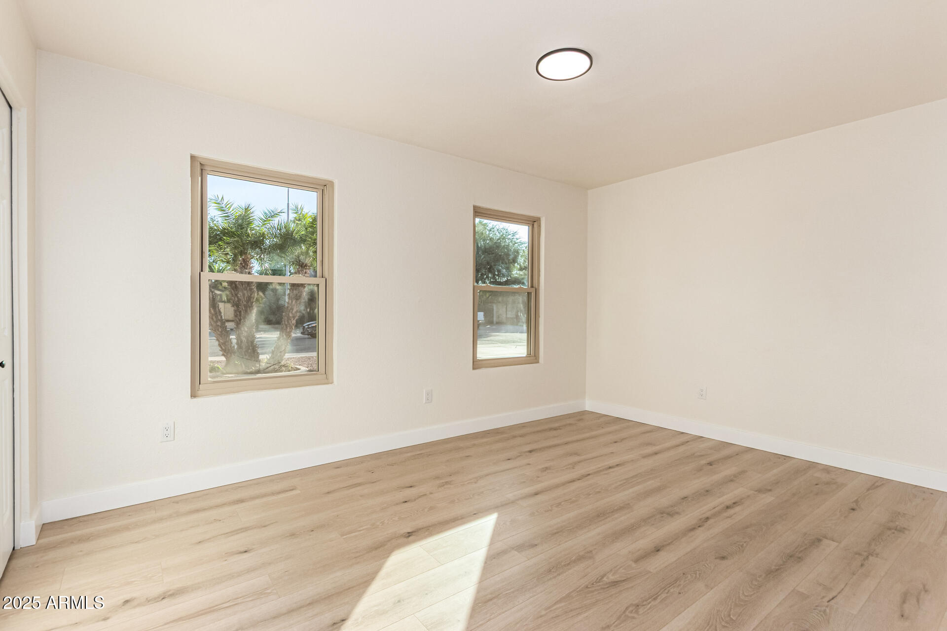 1514 West Loughlin Drive Chandler, AZ 85224 - Photo 20 of 33 an empty room with wooden floor and windows