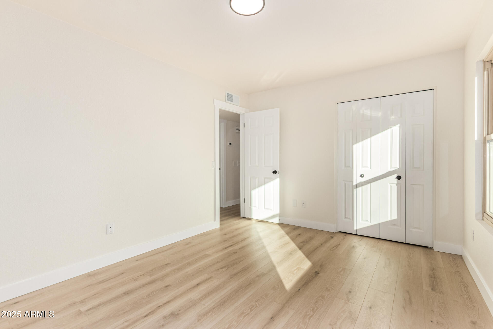 1514 West Loughlin Drive Chandler, AZ 85224 - Photo 21 of 33 a view of an empty room with wooden floor