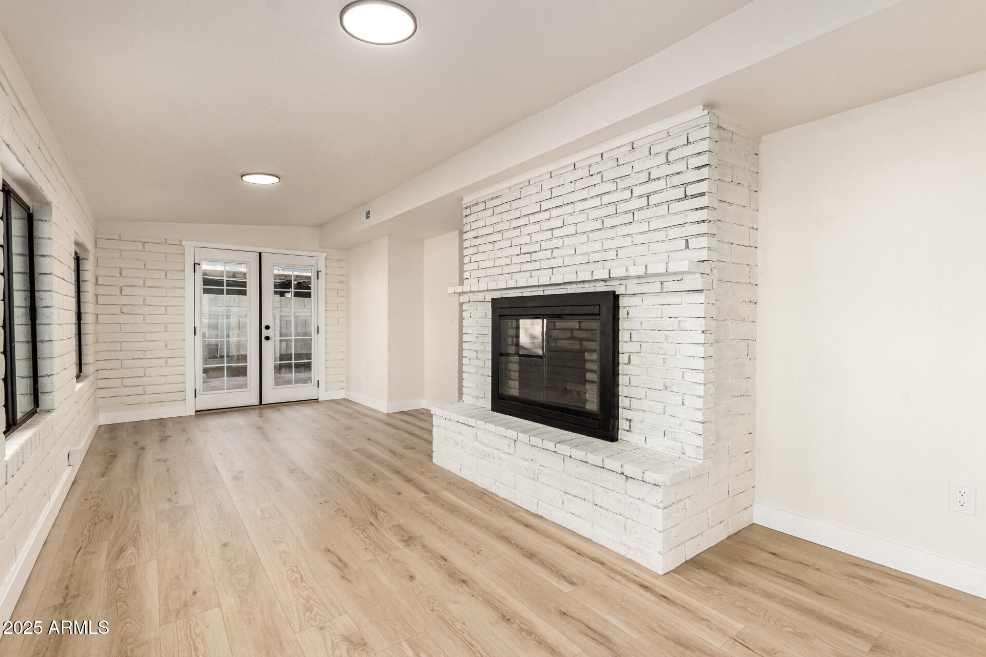 1514 West Loughlin Drive Chandler, AZ 85224 - Photo 26 of 33 a view of an empty room with wooden floor fireplace and a window