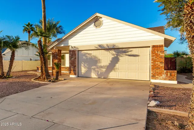 a view of a house with a yard and garage