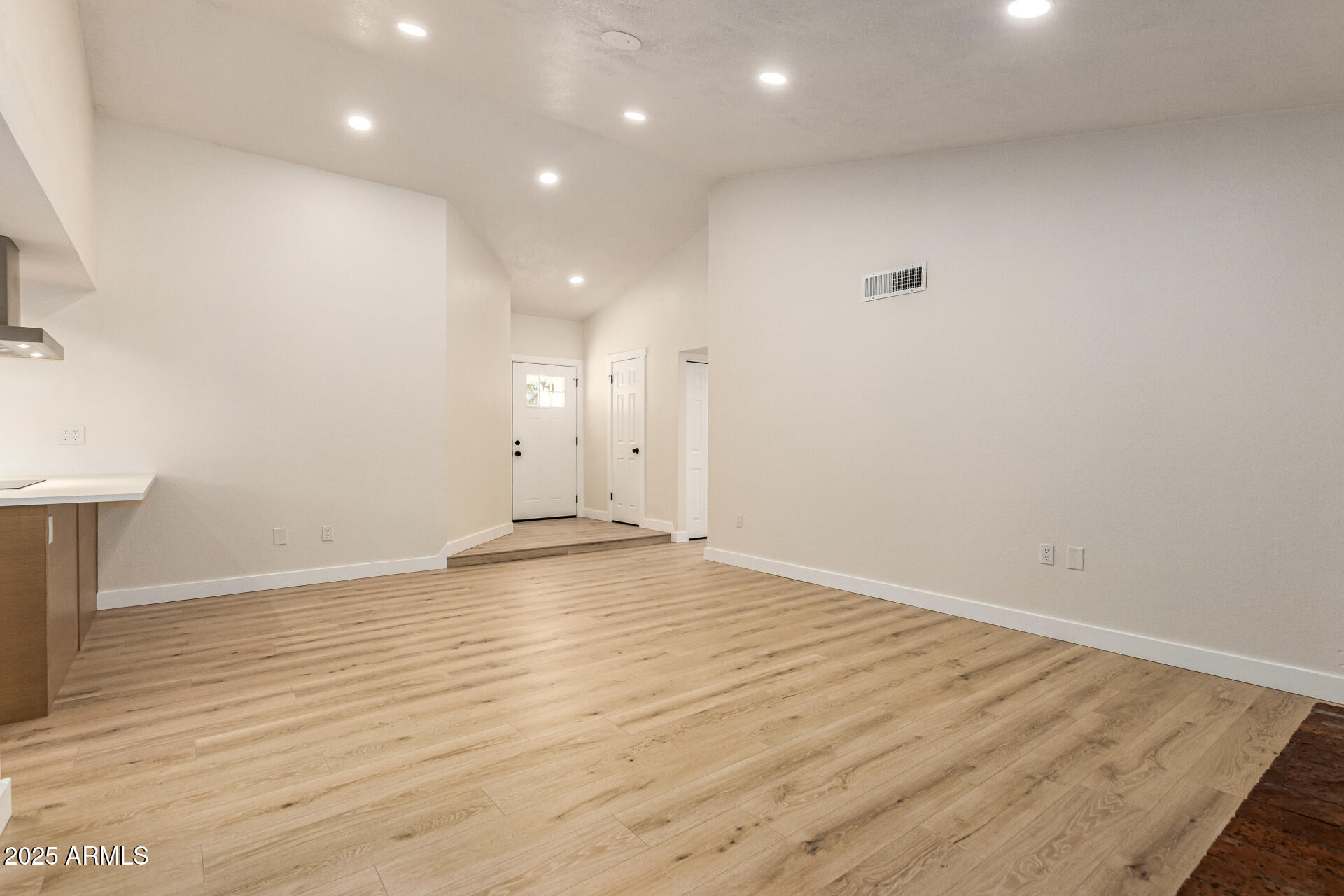 1514 West Loughlin Drive Chandler, AZ 85224 - Photo 10 of 33 an empty room with wooden floor and windows
