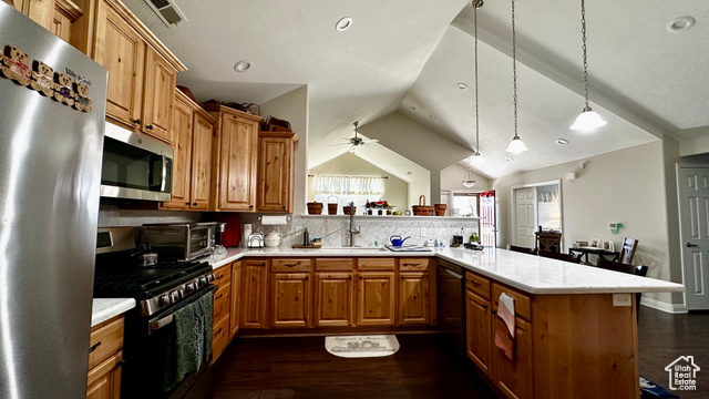 929 West 1920 South, Unit A Syracuse, UT 84075 - Photo 22 of 26 Kitchen featuring vaulted ceiling, appliances with stainless steel finishes, kitchen peninsula, pendant lighting, and decorative backsplash