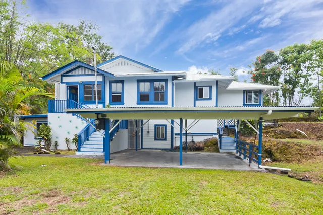 a view of a house with pool and chairs