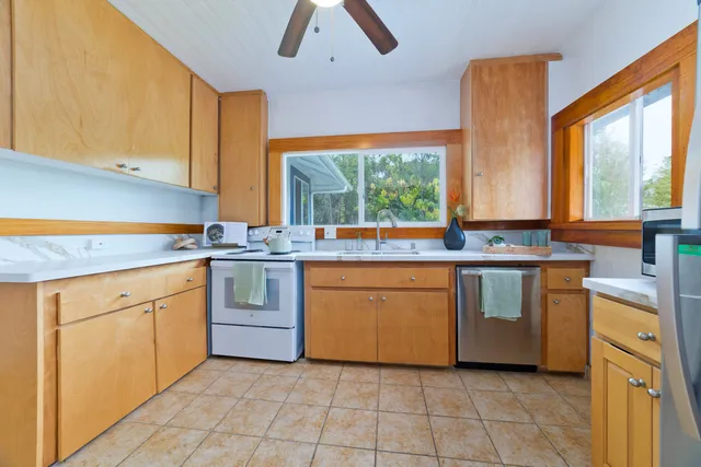 a kitchen with a stove sink and cabinets
