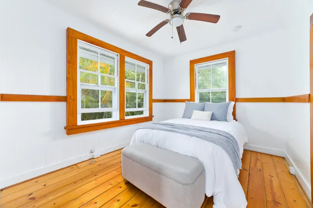 a bed sitting in a bedroom next to a window