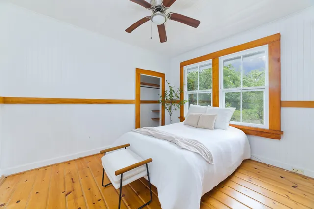 a bedroom with a bed and a window