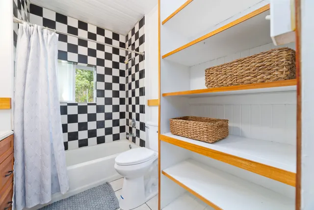 a bathroom with a toilet and shower