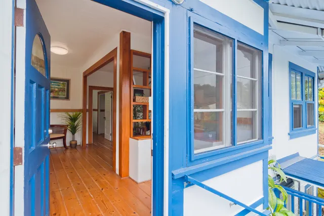 a view of a hallway with a dining table & chairs