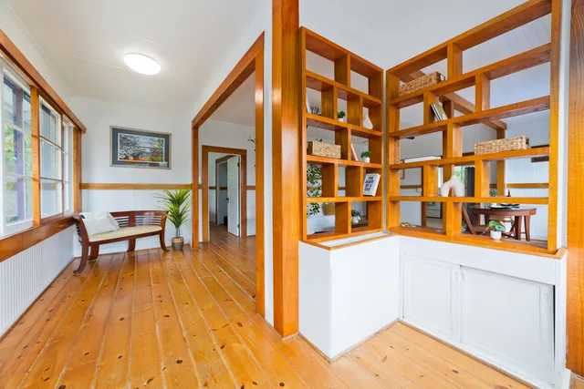 a view of a living room filled with furniture and wooden floor